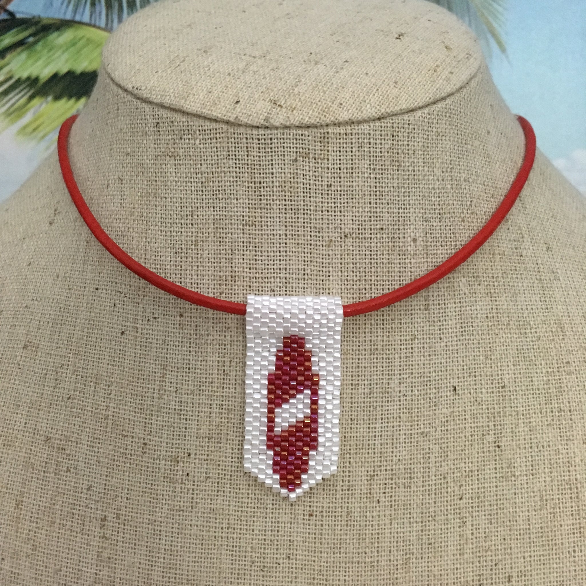 Handmade beaded mini surfboard pendant on leather cord red and white